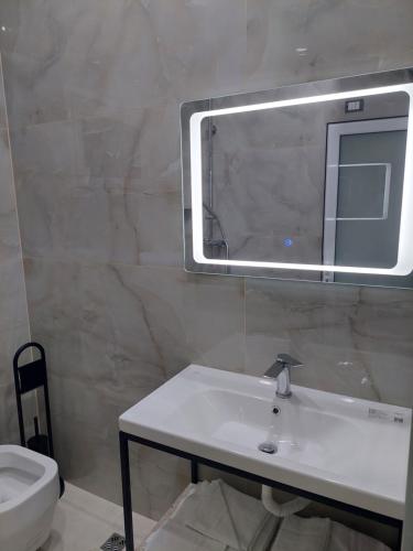 a bathroom with a sink and a mirror on the wall at SOLE INN in Vlorë