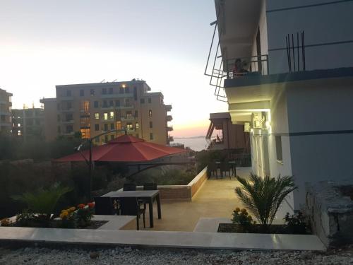 a balcony of a building with a table and chairs at SOLE INN in Vlorë