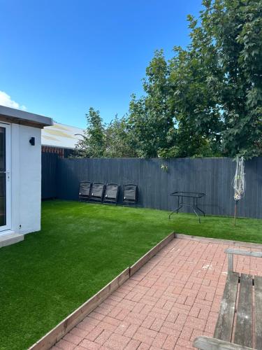 a backyard with a table and chairs and a fence at 2 bedroom semi-detached house- sleeps 4 in Newport