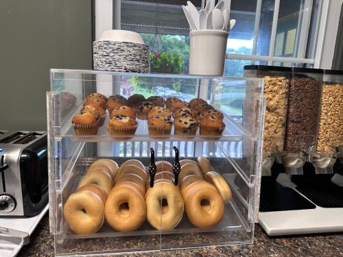 a display of donuts and muffins on a counter at Swiss Chalets Village Inn in North Conway
