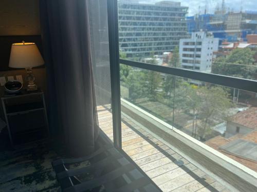 a room with a window with a view of a city at 8010 Urban Living- Luxury Home Experience in Bogotá