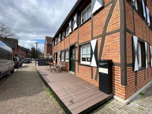 een gebouw met een houten terras aan de zijkant bij Charmantes Fachwerkhaus im Münsterland in Drensteinfurt