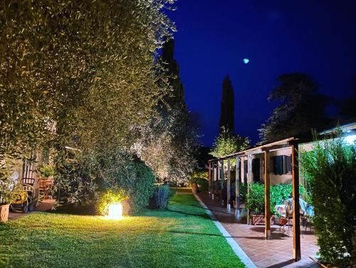 a garden with a fire in the grass at night at Ghiaccio Bosco in Capalbio