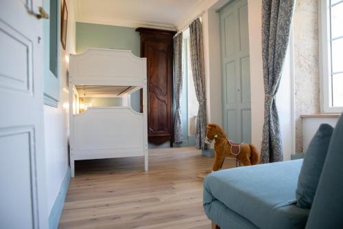 a bedroom with a horse standing in the middle of a room at Manoir du Colombier in Chavornay