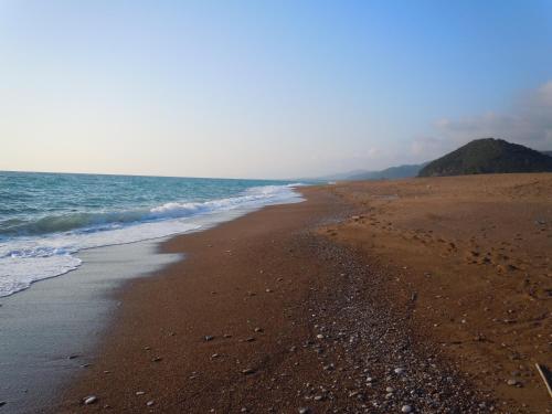 a beach with a few footprints in the sand at Irida Beach Resort Suites in Kyparissia