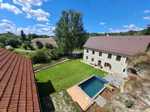 an aerial view of a house with a yard with a swimming pool at Chalupa Zátyní - celý objekt in Dubá