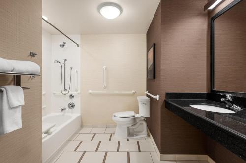 a bathroom with a toilet and a sink and a bath tub at Fairfield Inn & Suites by Marriott Hershey Chocolate Avenue in Hershey
