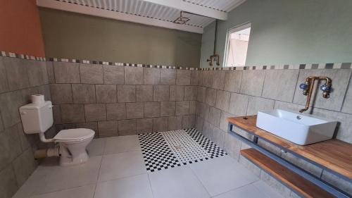 a bathroom with a toilet and a sink at ZuriCamp - Tent Zahir in Tsumeb