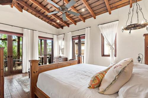 a bedroom with a large bed with a wooden ceiling at Casa Maya in Potrero