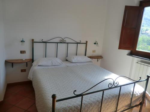 a bedroom with a bed with a metal frame at Agriturismo Mare e Monti in Tramonti