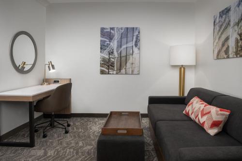 a living room with a couch and a desk at SpringHill Suites by Marriott Portland Vancouver in Vancouver