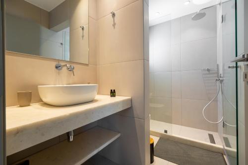 a bathroom with a sink and a shower at ALTHEA PAROS in Naousa