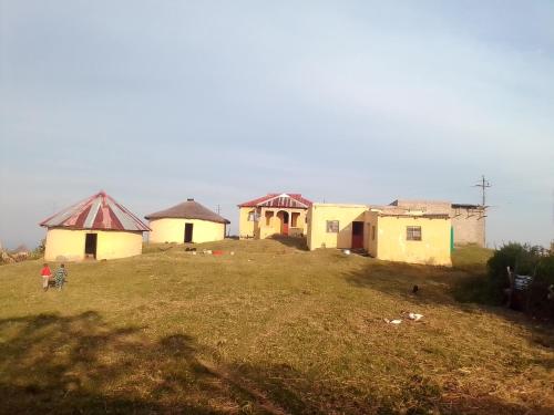 a group of houses on top of a hill at Tshezi Family in Ngqeleni