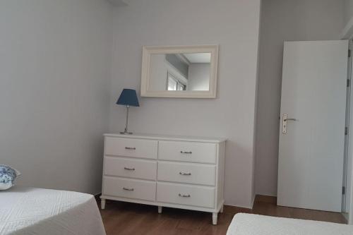a bedroom with a white dresser and a mirror at Villa con vistas al mar y piscina privada Oued Aliane in Mrarech