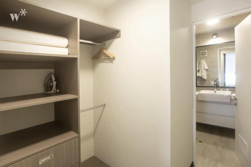 a bathroom with a toilet and a sink and a mirror at Pionero by Wynwood House in Lima
