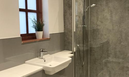 a bathroom with two sinks and a shower at Home with superb view of St Andrews in St Andrews