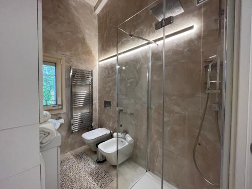a bathroom with a shower and a toilet and a sink at Antica Fonte Holiday Homes in San Pantaleo