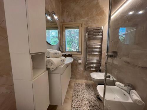 a bathroom with a sink and a toilet and a shower at Antica Fonte Holiday Homes in San Pantaleo