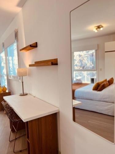 a bedroom with a mirror next to a bed at Sucre Suites in Buenos Aires