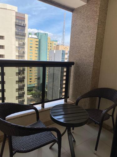 a balcony with two chairs and a table and a window at HOSPEDE-SE JÁ CULLINAN PARTICULAR in Brasilia