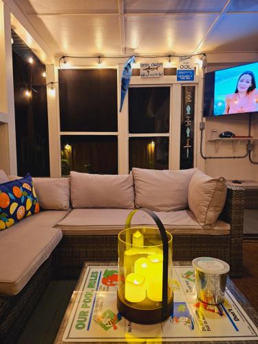 a living room with a couch and a tv at Beautiful Clearwater home! in Clearwater