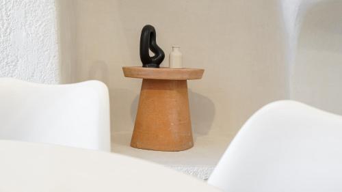 a small wooden container with a bottle and a scissors at White Haven Cave Home in Mesaria