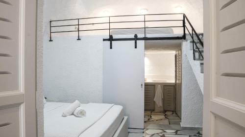 Dormitorio pequeño con litera y espejo en White Haven Cave Home en Mesaria