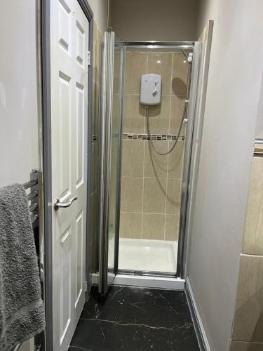 a shower with a glass door in a bathroom at One Bed Studio Apartment 