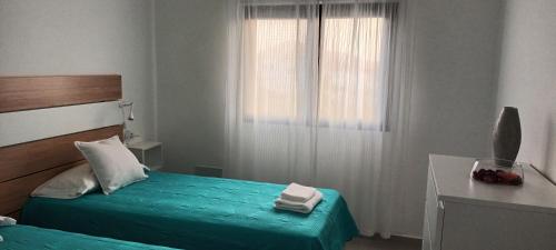 Katil atau katil-katil dalam bilik di Apartamentos Falcón