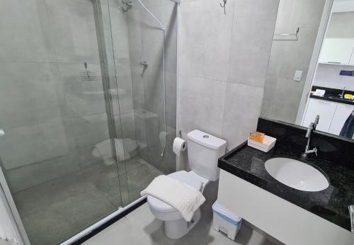 a bathroom with a shower and a toilet and a sink at Porto Vila by AFT in Porto De Galinhas