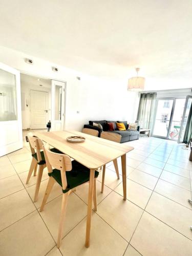 a dining table and chairs in a living room at Plaza Antibes one bedroom apartment with a parking spot in Antibes