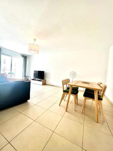 a dining room with a table and chairs at Plaza Antibes one bedroom apartment with a parking spot in Antibes