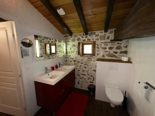 a bathroom with a sink and a toilet at Domaine de Brise Bois - Chambres & Gîtes in Rouzède