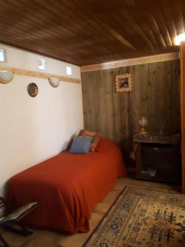 a bedroom with a red bed in a room at la maison de Juliette En bas in Lascabanes