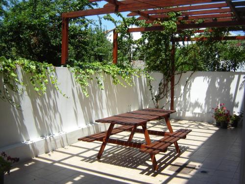a picnic table and a bench on a patio at Pansion Chrisa in Skiathos Town