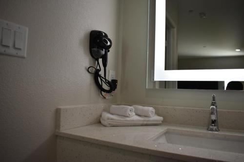 a bathroom with a sink and a phone on the wall at Blue Star Inn in Houston