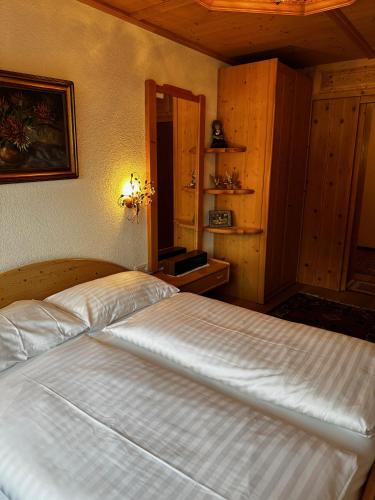 a bedroom with a large white bed in a room at Appartementhaus Birkenwald in Seefeld in Tirol