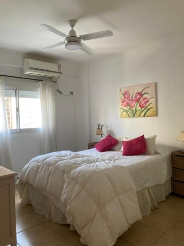 a bedroom with a bed with two red pillows at Portales I in Santa Fe
