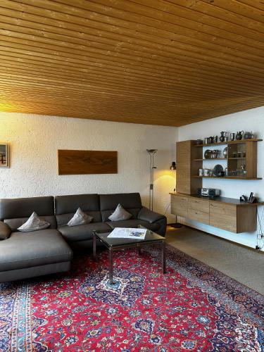 a living room with a couch and a table on a rug at Appartementhaus Birkenwald in Seefeld in Tirol
