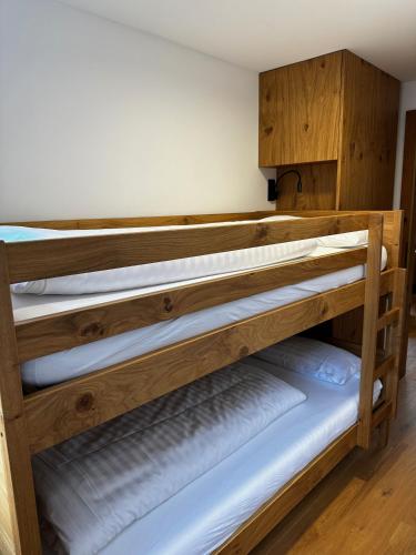 two wooden bunk beds in a room at Appartementhaus Birkenwald in Seefeld in Tirol