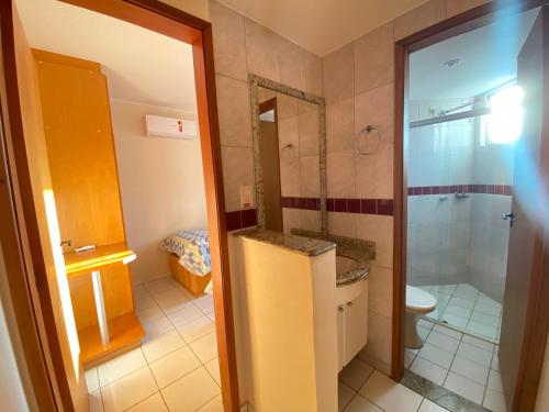 a bathroom with a toilet and a sink and a shower at Apto 2 Quartos Caldas Novas Millennium com Wi-Fi in Caldas Novas