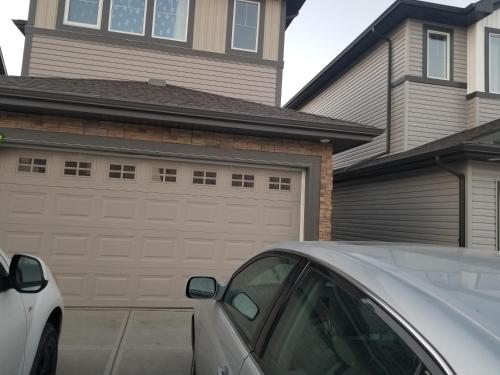 a car parked in front of a garage at Newcastle. A Place you can call home in Edmonton