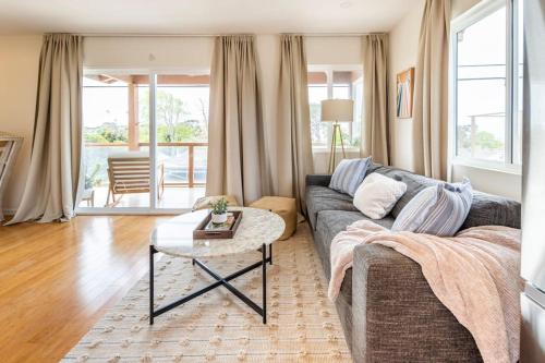 a living room with a couch and a table at Stylish Guest House with Ocean & City Views in San Diego