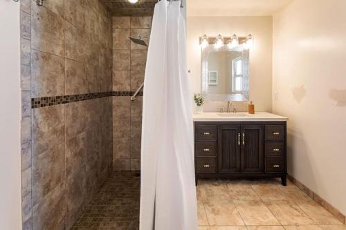 a bathroom with a shower and a sink at Stylish Guest House with Ocean & City Views in San Diego