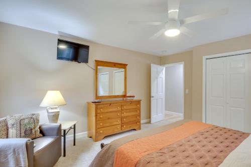 a bedroom with a bed and a dresser and a mirror at Waterfront Lakehouse with Private Dock and Fire Pit! in Chapin