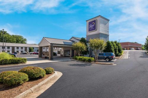 a building with a sign on it in a parking lot at Sleep Inn Kernersville I-40 in Kernersville
