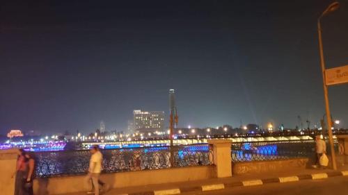 a group of people walking on a bridge at night at Spacious Panthouse Center of Cairo exotic location in Cairo