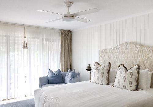 a bedroom with a white bed and a window at The Lord Byron in Byron Bay