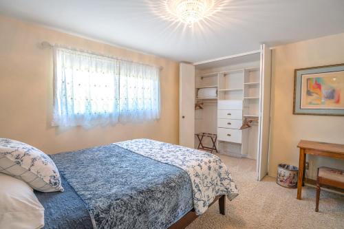 a bedroom with a blue bed and a window at Highland Park House in Walla Walla