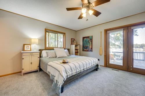 a bedroom with a bed and a ceiling fan at Delton Oasis Retreat with Lake Views and Deck! in Delton
